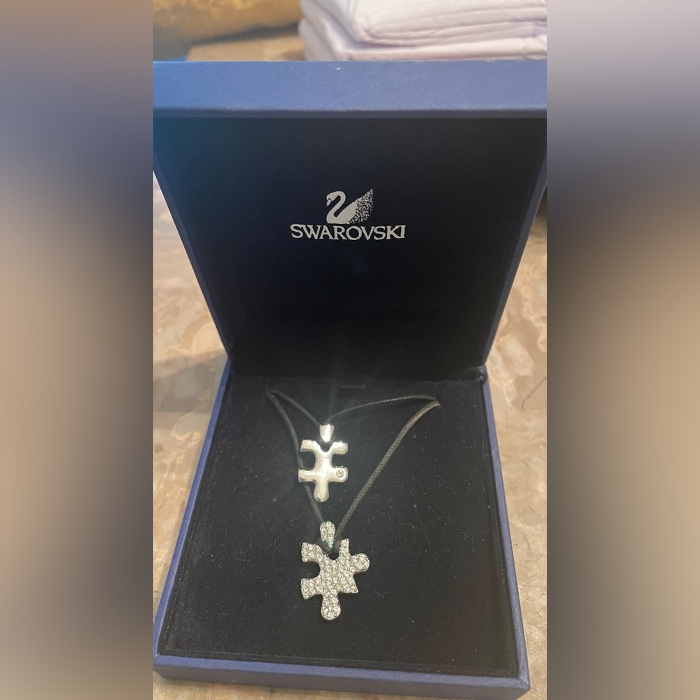 Swarovski Necklaces, 2 separate puzzle pieces, leather necklace each tie